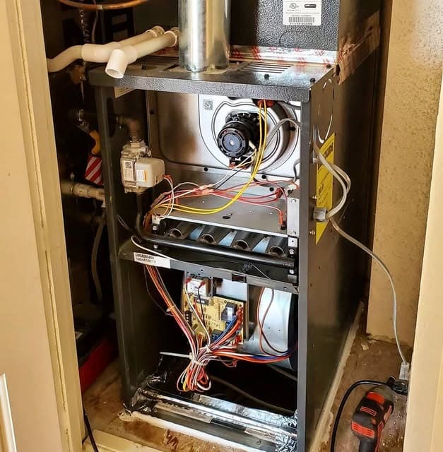 Furnace opened up for inspection of parts, connections and controls